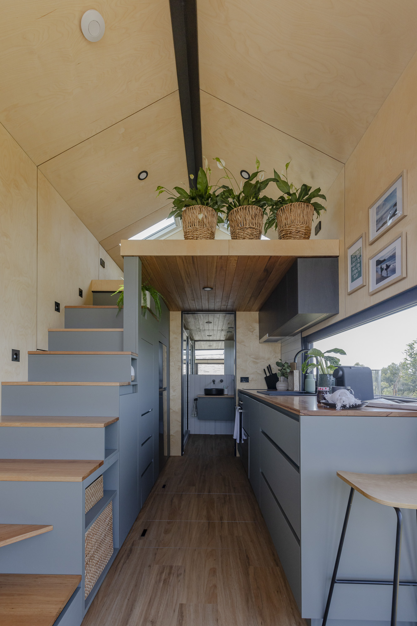 Open-Plan Kitchen and Living Area | Luxe Loft Tiny Home Open-plan kitchen and living area in the Luxe Loft Tiny Home with bright natural light and functional storage