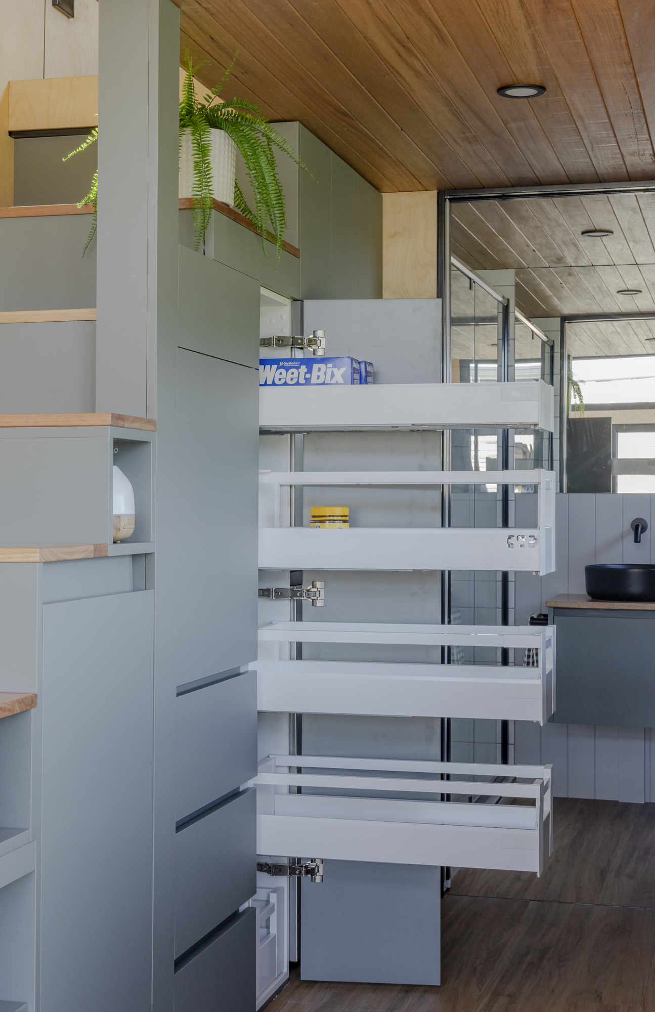 Tiny House Design Australia 1_71 Ample built-in storage for clothes and kitchen essentials inside the Luxe Loft Tiny Home by Manuka Tiny Homes