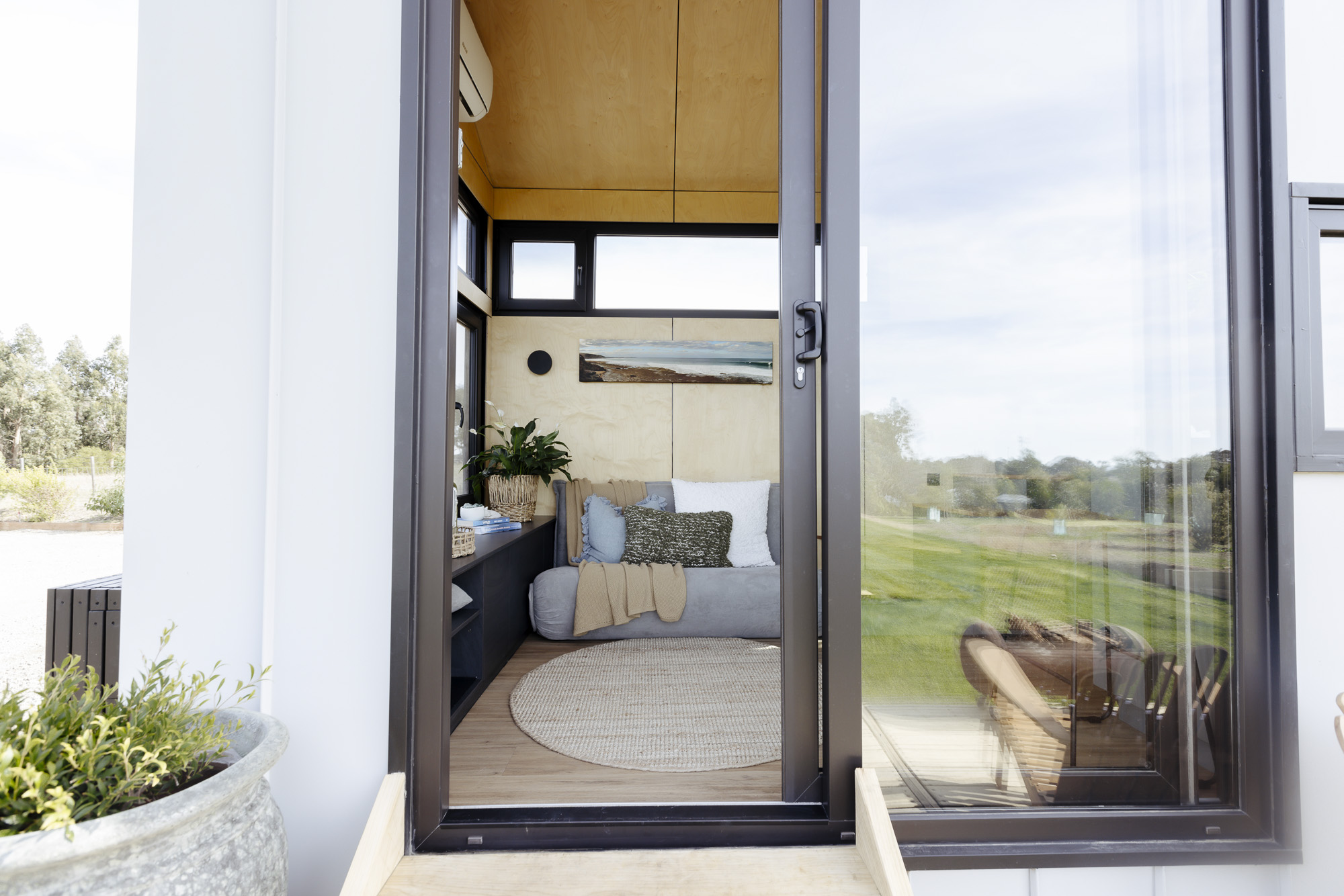 Timber decking adding an outdoor area to extend the tiny home on wheels
