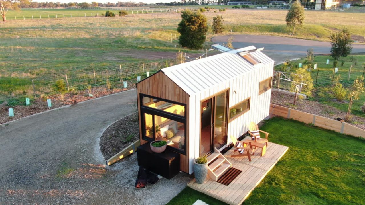 Luxe Loft Tiny Home for Sale – 7.2m designer home on wheels featuring Blackbutt timber, large windows, and off-grid capability.