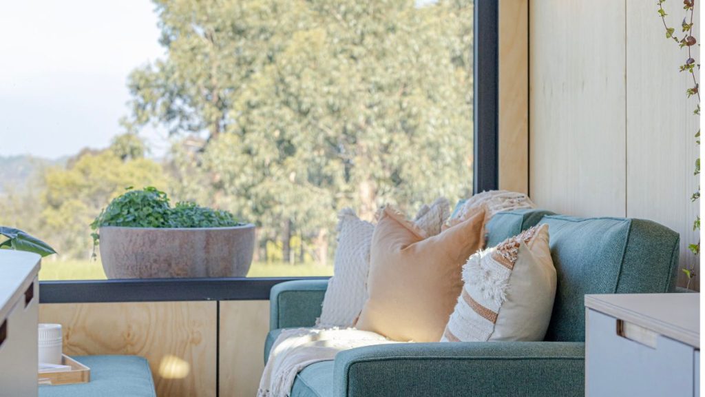 Tiny home on wheels interior with couch and natural outlook