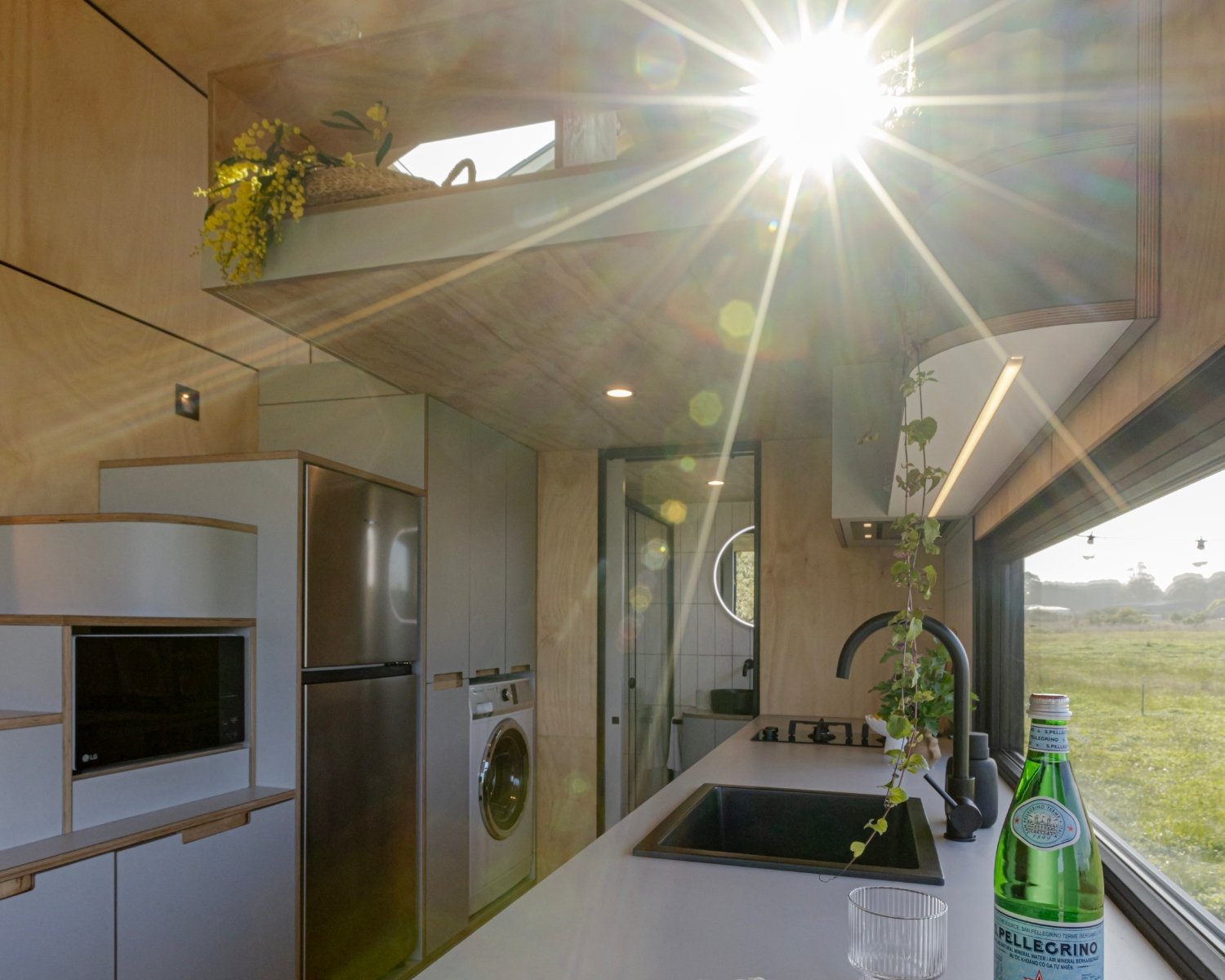 Natural light streaming through the windows of a tiny home on wheels in Victoria